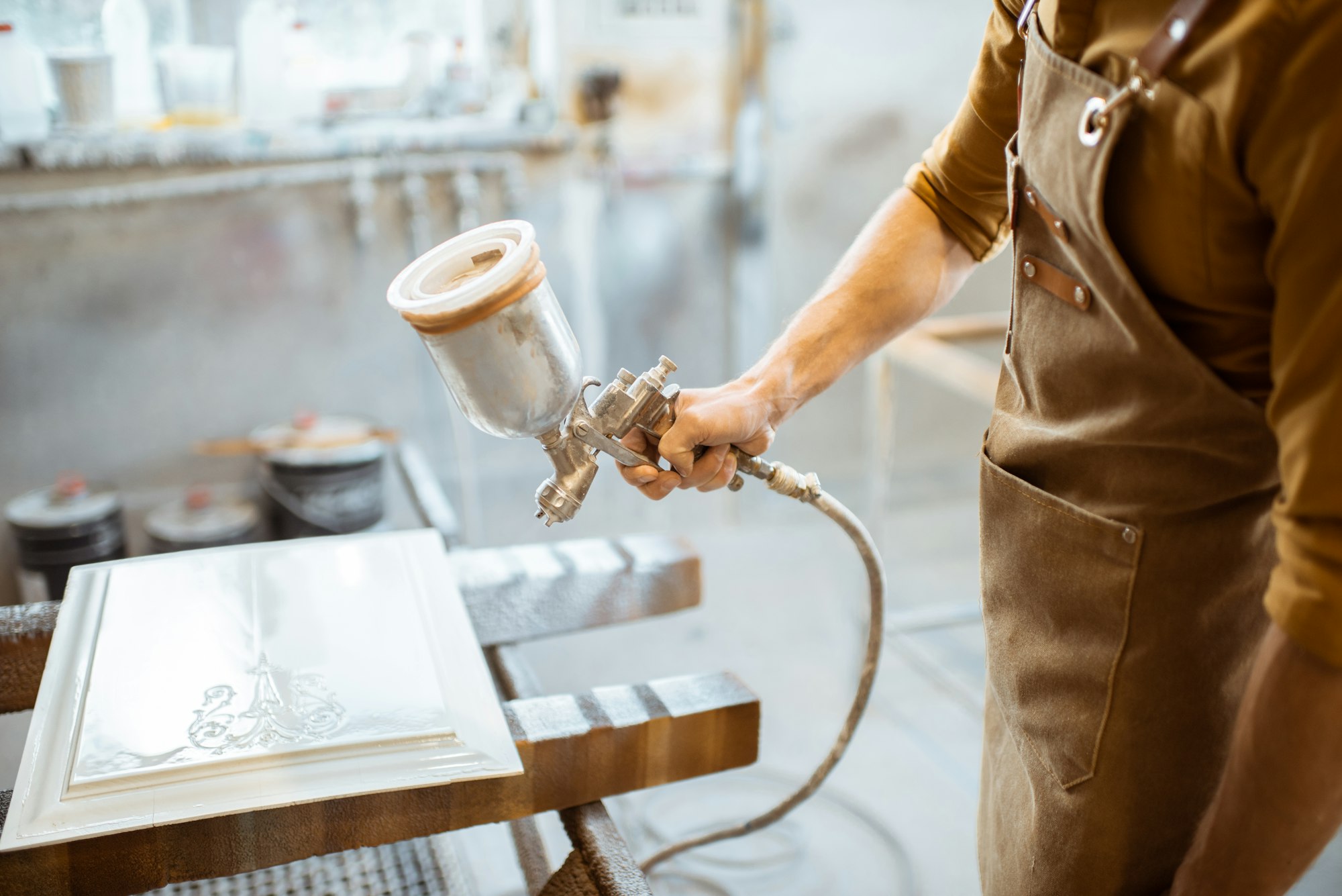 Painting wooden product with a spray gun